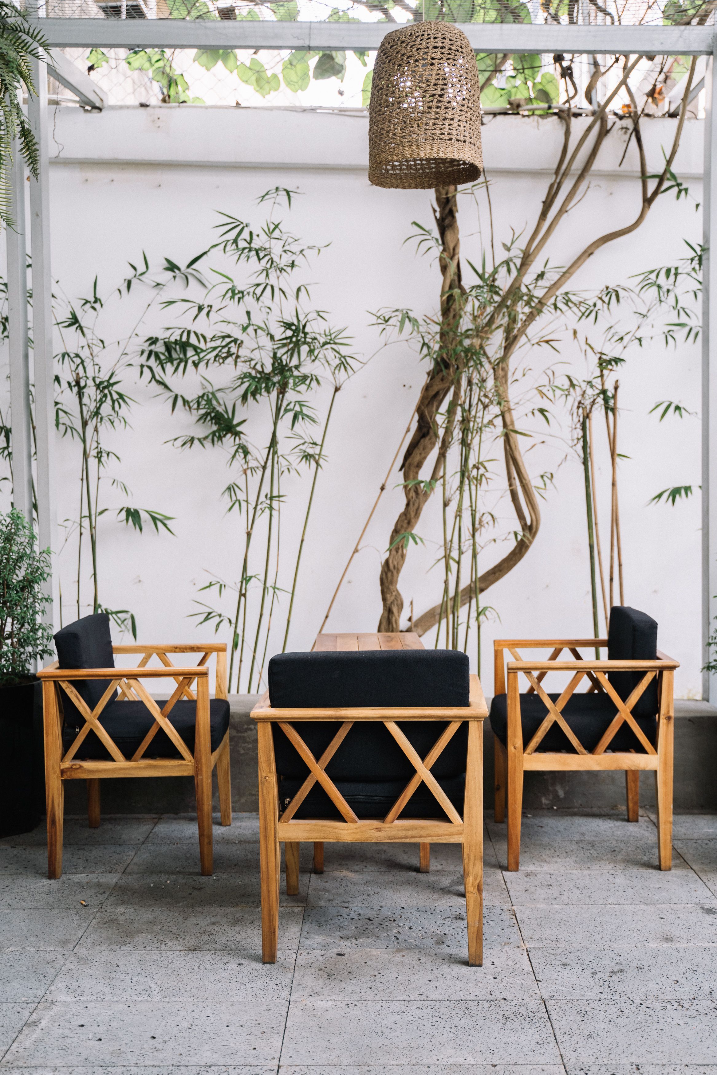Bold modern bamboo accent chair with an arched barrel back and natural hemp cord weave